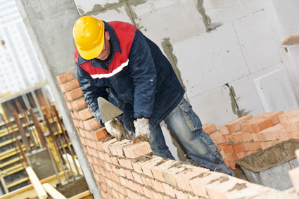 Once Planning and Building Regulations approval is granted, the build can commence Man Laying Brick and mortar